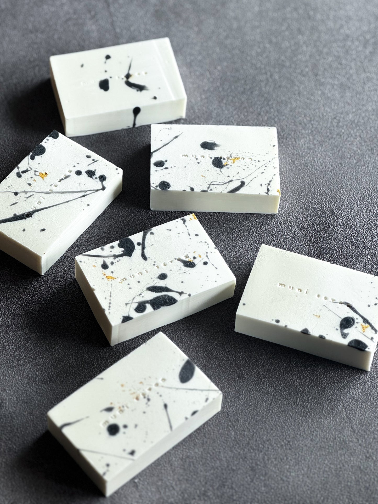 Artisan soap with expressive ink splash markings and sculptural details