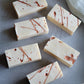 Minimalist handcrafted soap with abstract copper splatter design