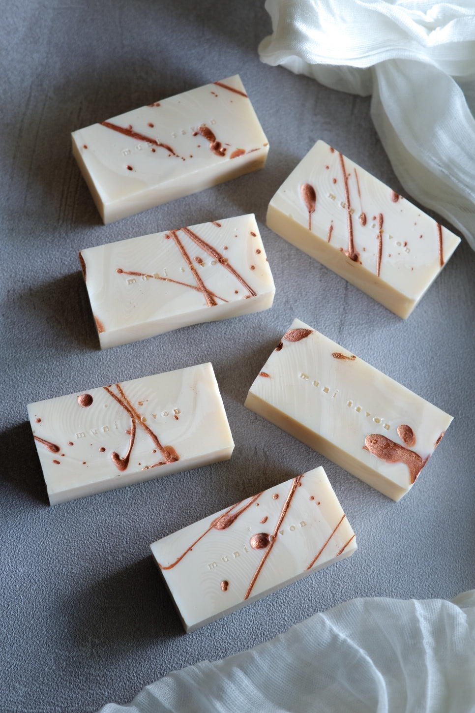 Minimalist handcrafted soap with abstract copper splatter design
