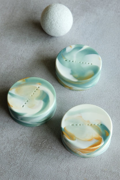 Round handmade artisan soap with marble textures and subtle gold details
