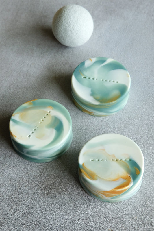 Round handmade artisan soap with marble textures and subtle gold details