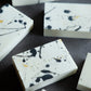 Handmade minimalist artisan soap with black ink splatter details and gold foil accents