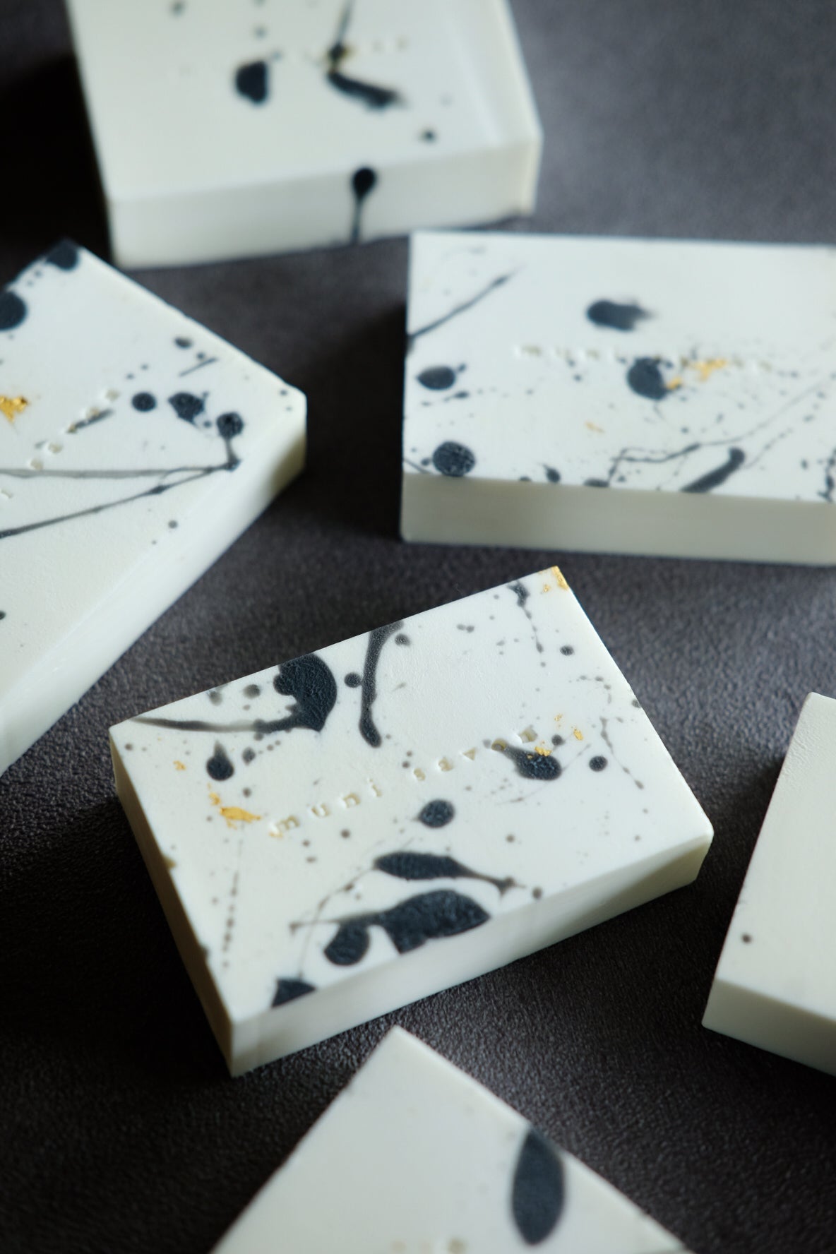 Handmade minimalist artisan soap with black ink splatter details and gold foil accents