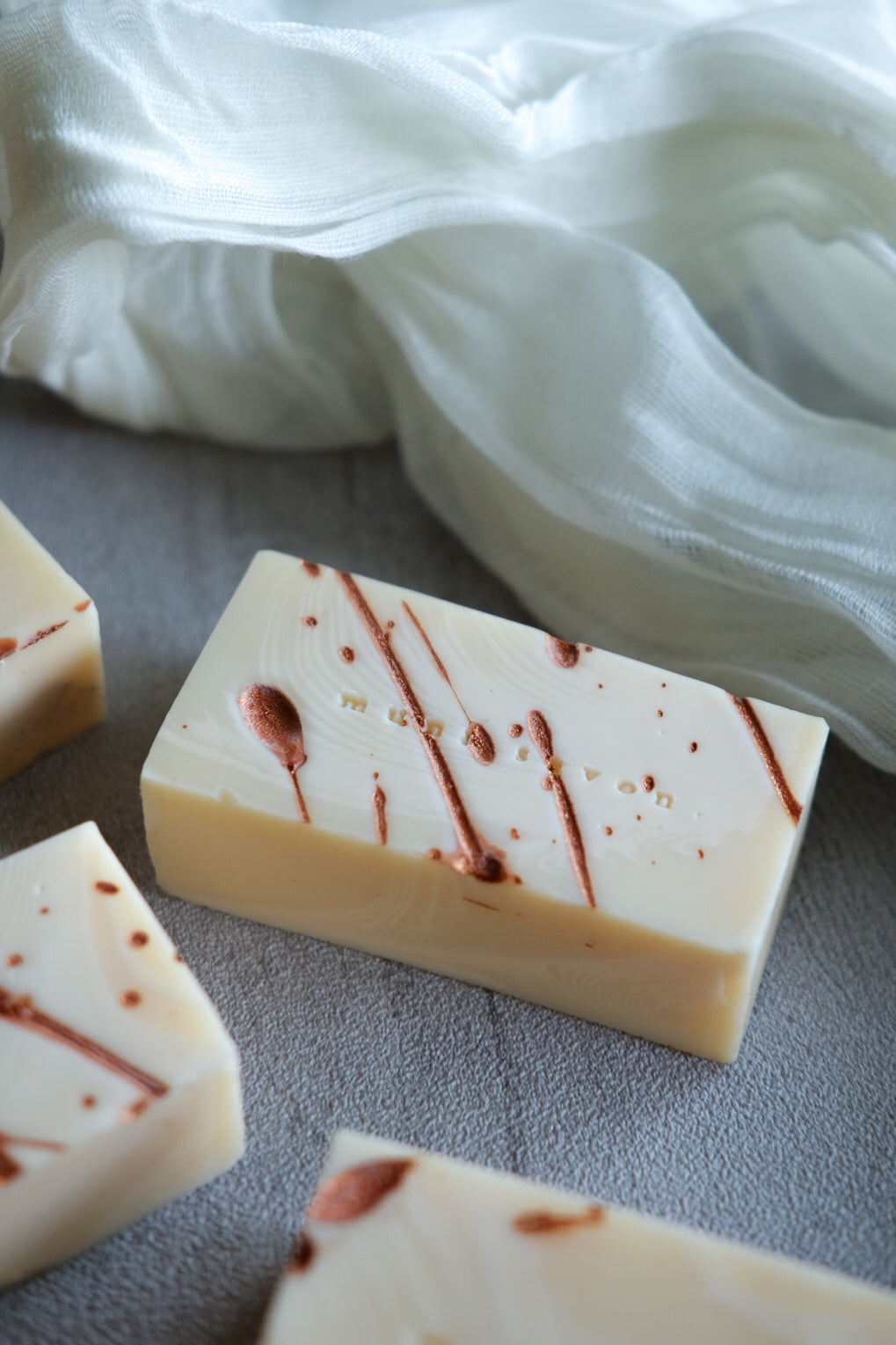 Unscented artisan soap inspired by ripple textures and metallic details