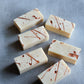 Artisan cold process soap with flowing copper markings and sculptural texture